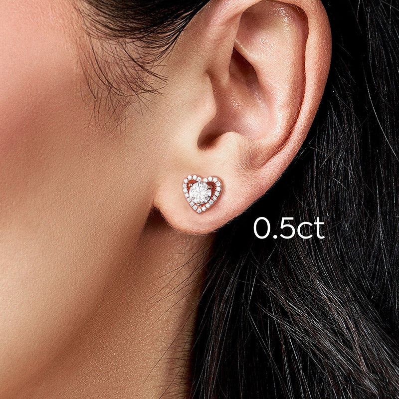 Woman wearing sparkling moissanite stud earrings.